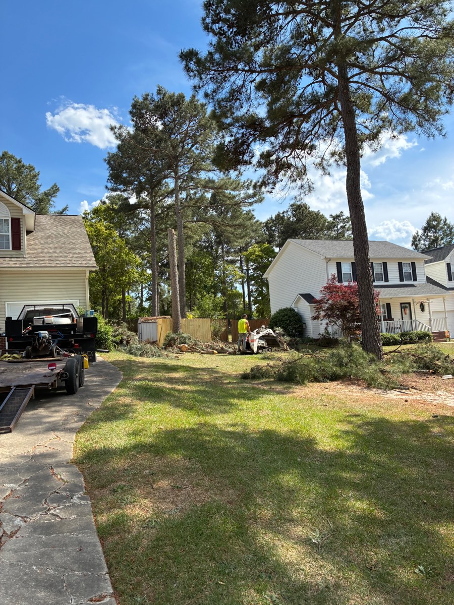 Storm debris staged for cleanup between two homes in Lee County, NC